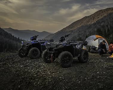 Two Polaris ATVs and a Tent